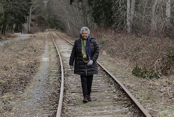 woman walking on train tracks
